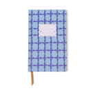 Tulip journal with a wavy blue lattice on a pale blue cover, a blank scalloped label and a tan ribbon marker