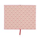 Matching pink and red bow-print endpapers inside the cover