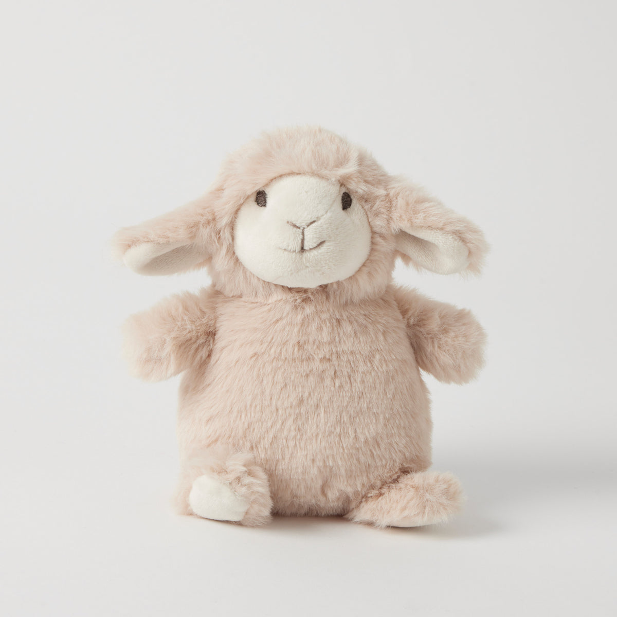 Cream plush lamb rattle sitting up, with a smooth pale face, floppy ears and cream feet