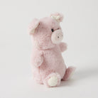 The pink piglet rattle from the side, showing its round body and cream feet