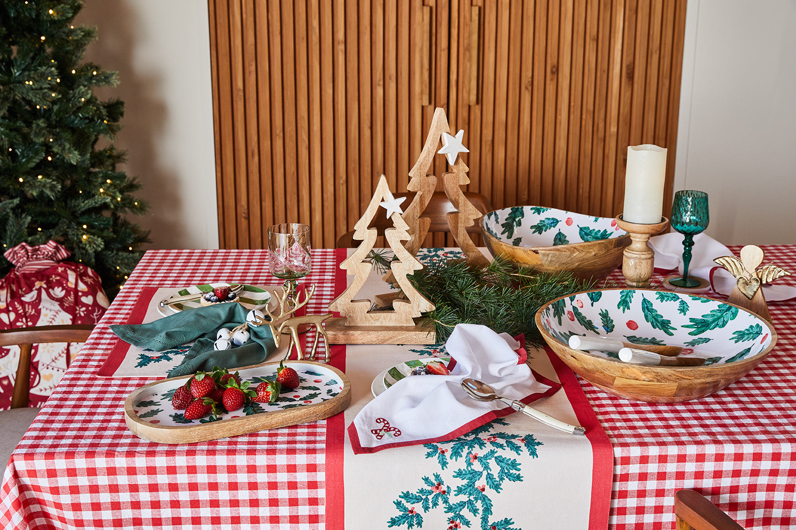 Festive table styled with wooden Christmas trees, holly serveware and the Gaberial angel range