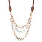 Jireh necklace in gold: three strands of large gold oval links on a tan faux-leather cord