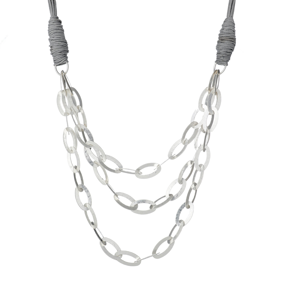 Jireh necklace in silver: three strands of large silver oval links on a tan faux-leather cord