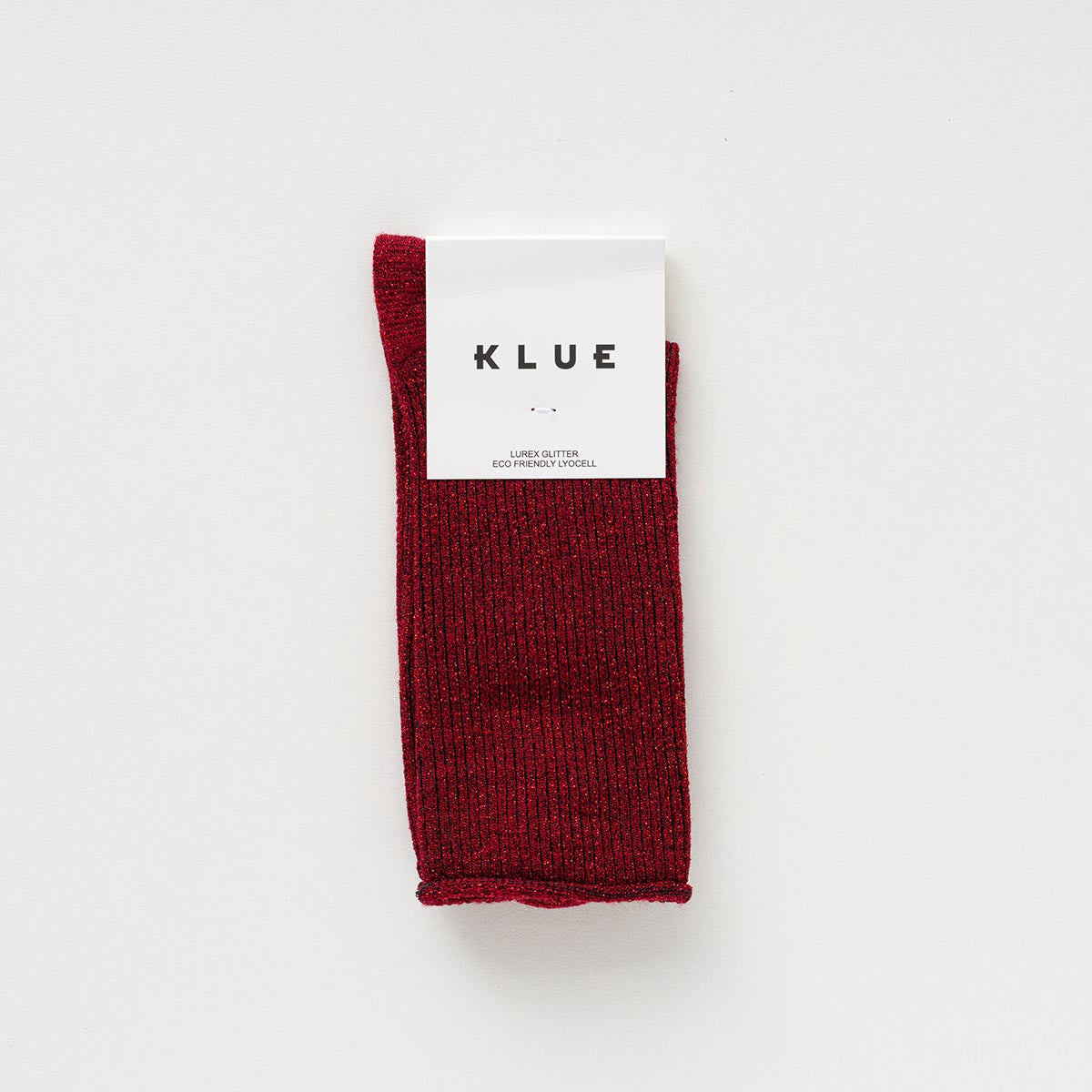 Cherry red KLUE glitter lurex socks folded in their branded paper band
