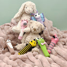 Knit hand rattles and plush toys arranged on a blanket