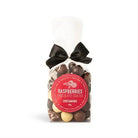 Clear cello bag of milk, dark and white chocolate-coated raspberries tied with a black satin bow, with a round red Chocamama label