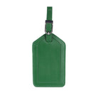 Emerald leather luggage tag from the front, hanging from its buckled strap