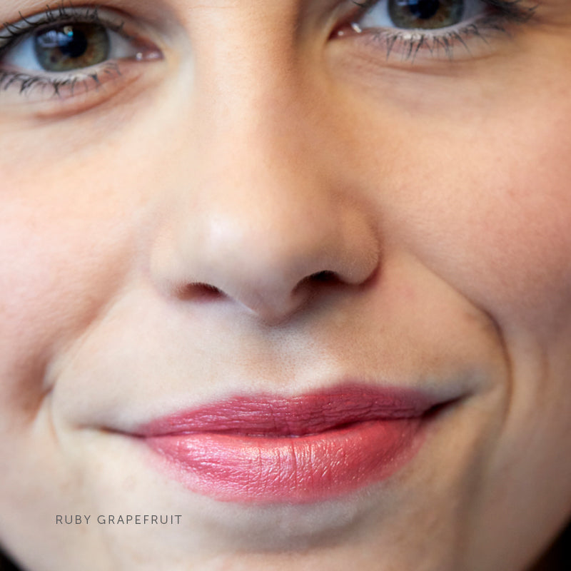 Lük Beautifood Lip Nourish natural lipstick in Ruby Grapefruit — worn on lips