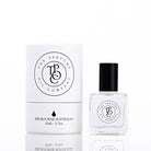The Perfume Oil Company white gift cylinder beside a 10 ml bottle of perfume oil, bottle to the right of the cylinder