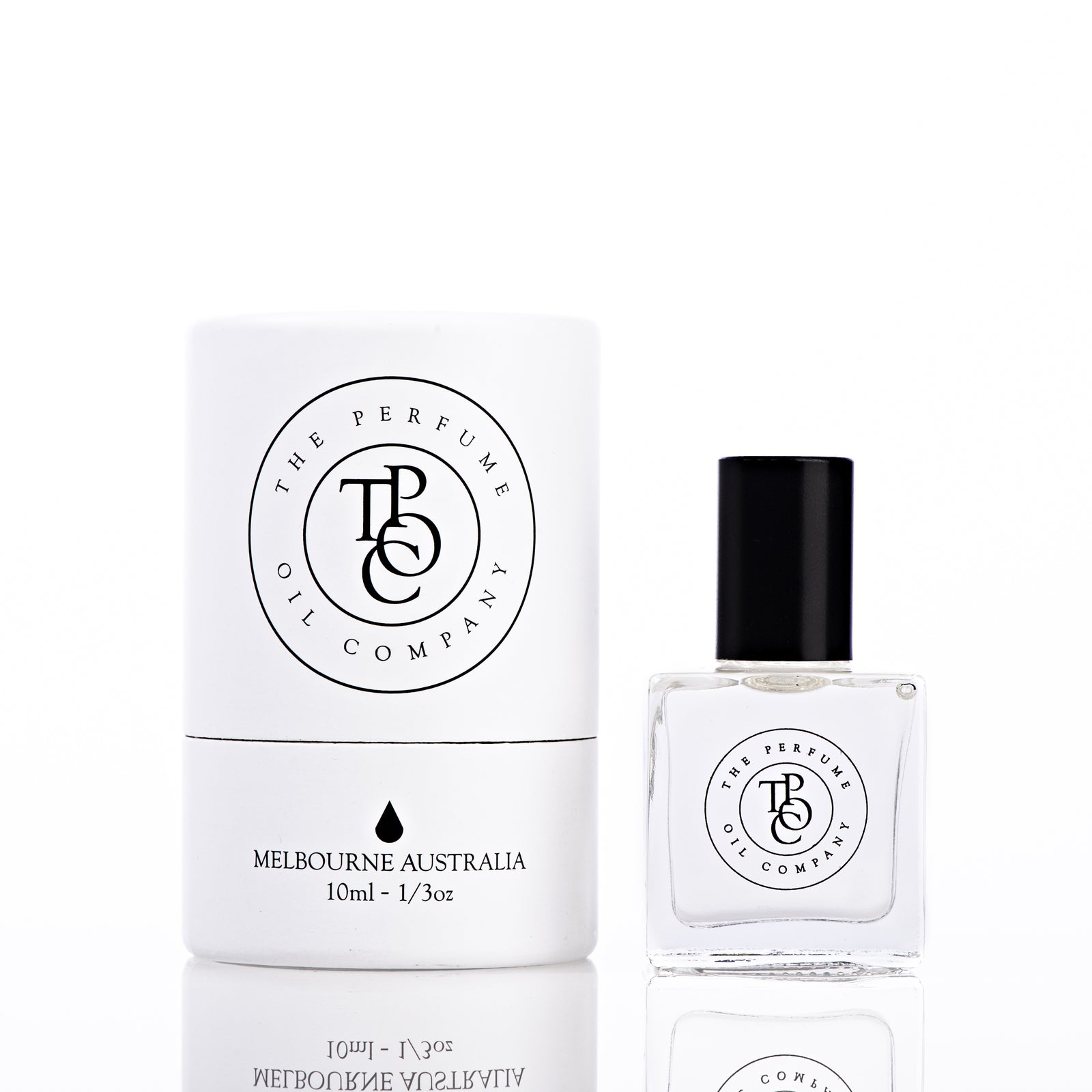 The Perfume Oil Company white gift cylinder beside a 10 ml bottle of perfume oil, bottle to the right of the cylinder