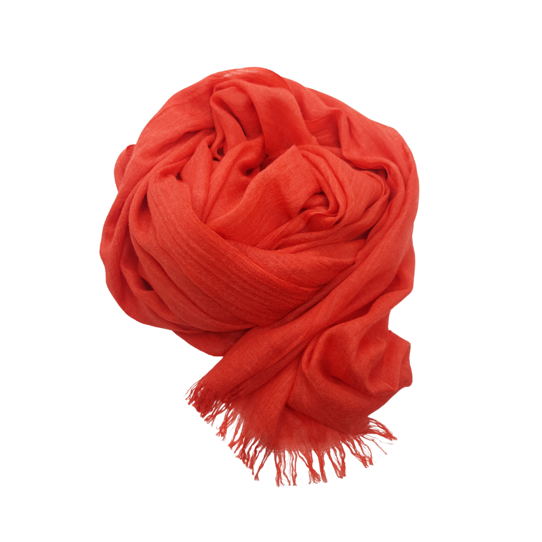 Beauty in Bamboo scarf in Lipstick, a vivid red-orange, loosely coiled