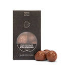 Chocamama milk chocolate freeze-dried strawberries box with three chocolates beside it