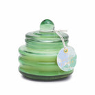 Green ribbed glass candle with a domed lid and a Cactus Flower hang tag.