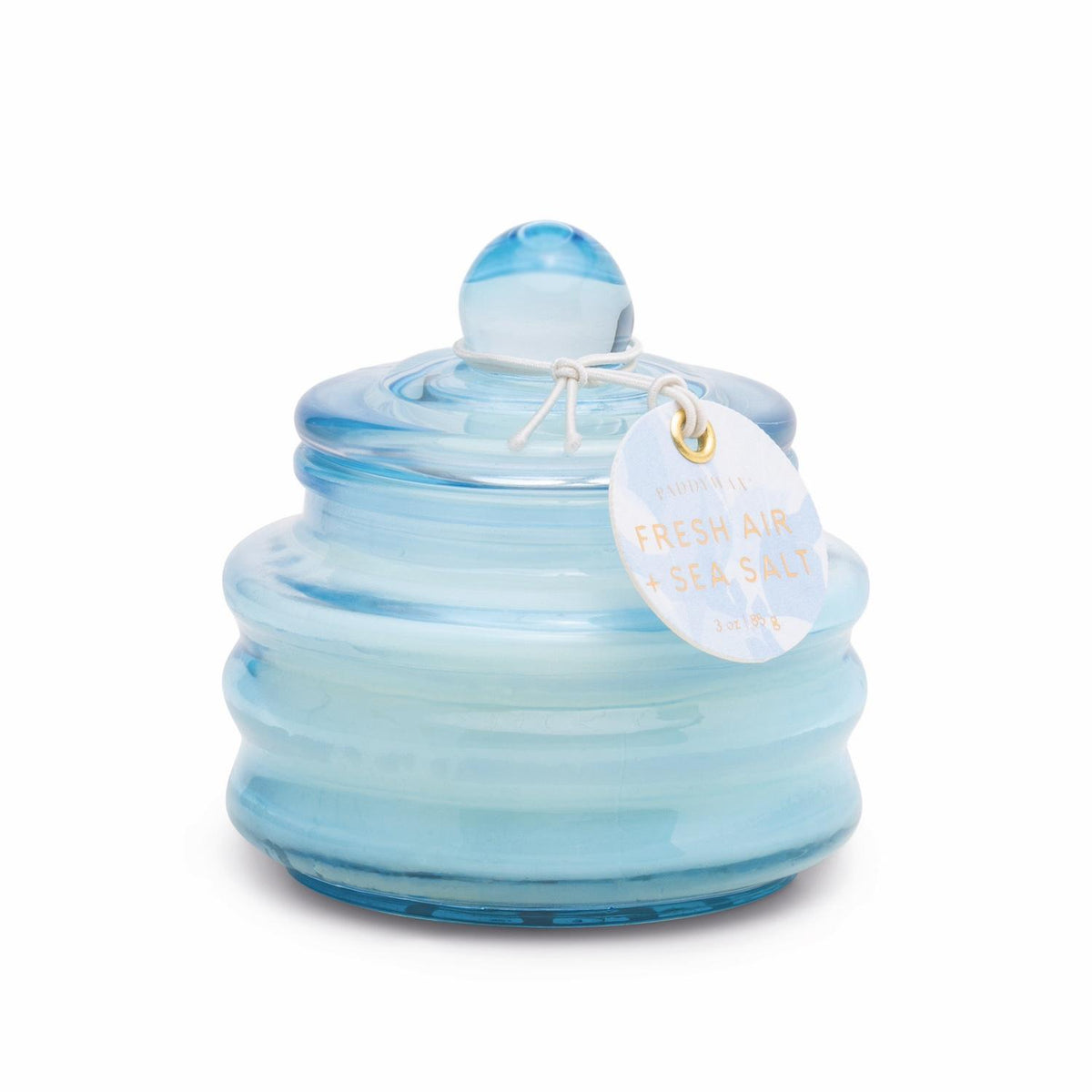 Pale blue ribbed glass candle with a domed lid and a Fresh Air + Sea Salt hang tag.
