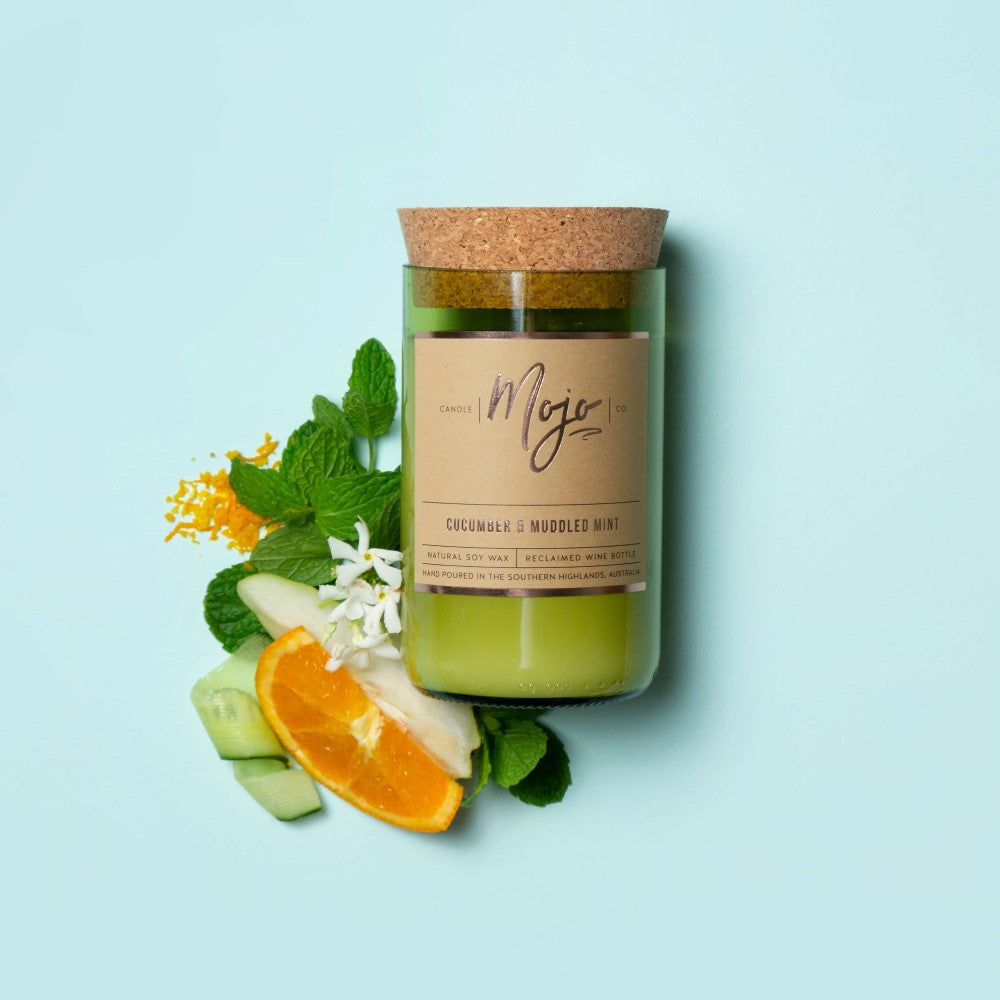 Cucumber & Muddled Mint soy candle in a cork-topped reclaimed wine bottle with orange, cucumber and mint