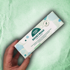 A hand holding the Mint Motorway rocky road box on a pale green background
