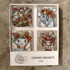 Boxed set of four ceramic magnets painted with a possum, koala, wombat and kangaroo in native Christmas florals and red bows