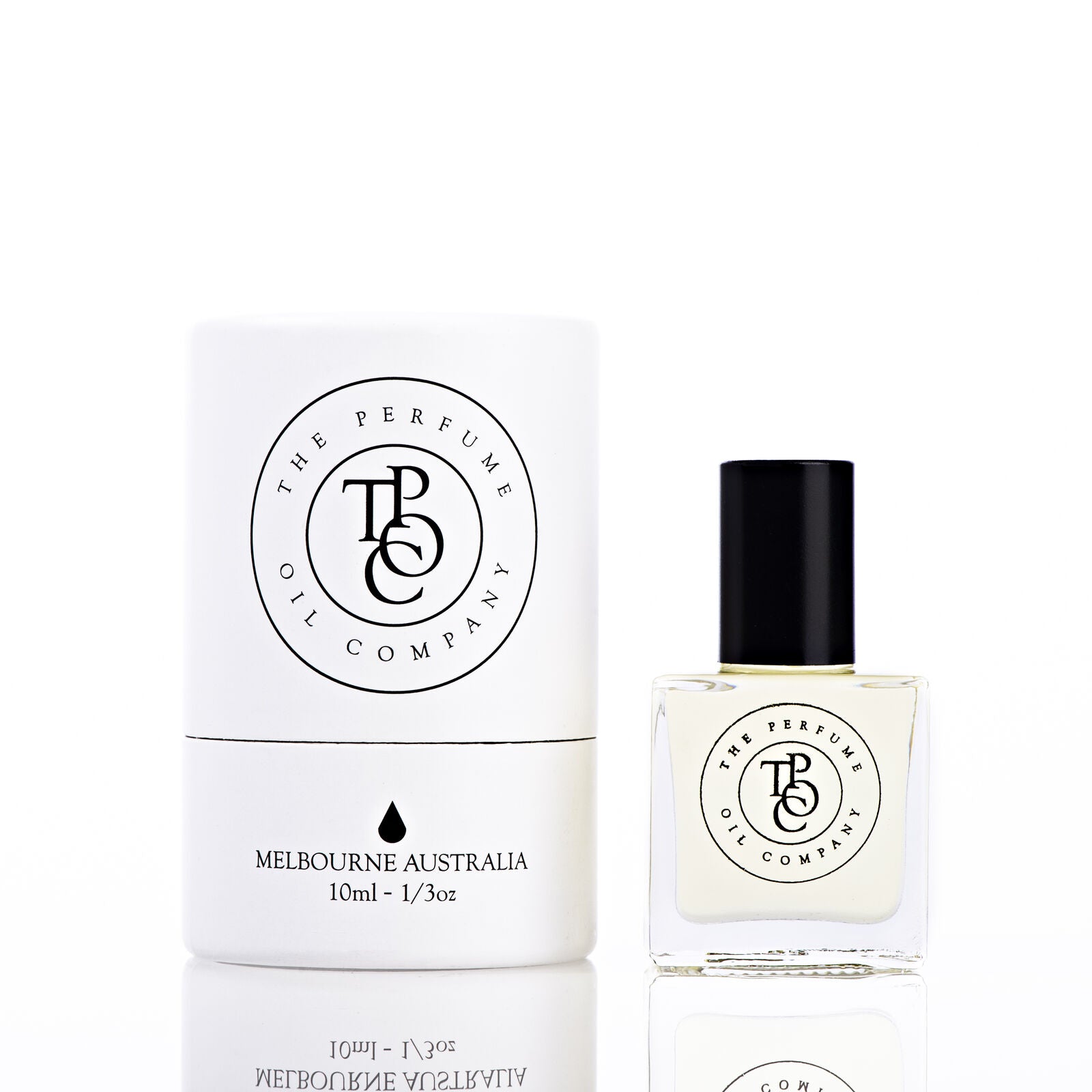 The Perfume Oil Company white gift cylinder beside a 10 ml bottle of perfume oil, bottle to the right of the cylinder