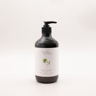 Myrtle & Moss Bergamot body lotion in a 500ml amber glass bottle with a black pump and a pale label showing a green geranium-leaf sprig.