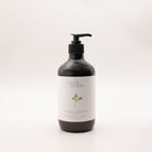 Myrtle & Moss Citrus body lotion in a 500ml amber glass bottle with a black pump and a pale label showing a green sprig.