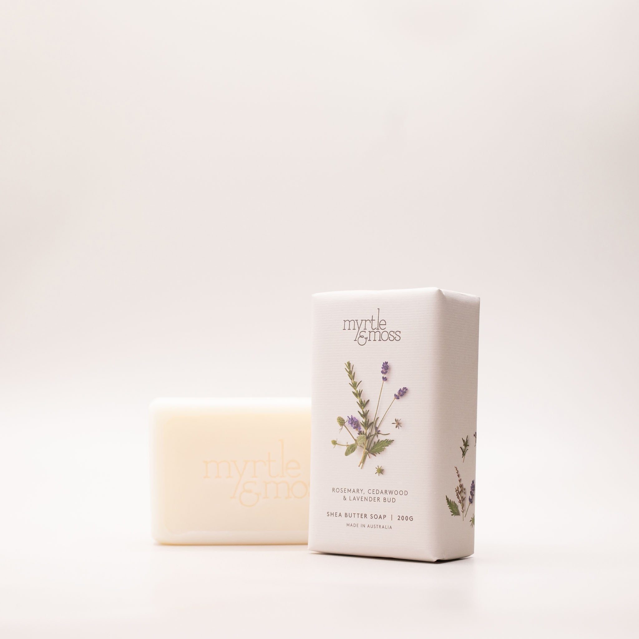 The Rosemary, Cedarwood & Lavender Bud soap box turned at an angle, showing its lavender print and the 200g Made in Australia label.