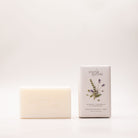 Cream shea butter soap bar beside its pale grey box, printed with purple lavender sprigs and labelled Rosemary, Cedarwood & Lavender Bud.