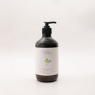 Myrtle & Moss Citrus hand and body wash in a 500ml amber glass bottle with a black pump and a pale label showing a green sprig.