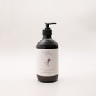 Myrtle & Moss Rose Geranium hand and body wash in a 500ml amber glass bottle with a black pump and a pale label showing a burgundy sprig.
