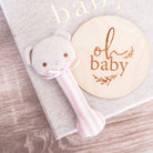 Ted bear stick rattle in pink stripe styled with an oh baby milestone disc