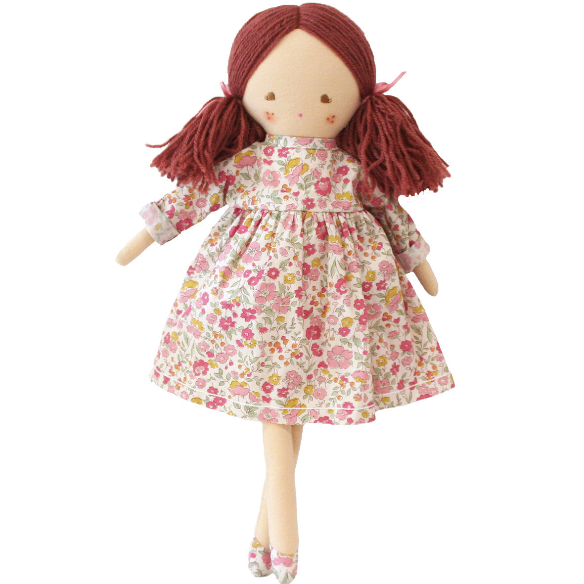 Matilda doll with dark red yarn pigtails wearing a pink floral print dress