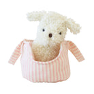 Marshmallow puppy plush sitting inside its pink striped carrier
