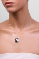 Model wearing the Chloe silver pendant necklace.
