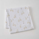 White cotton muslin wrap folded into a square, printed with small cream ducks and reeds