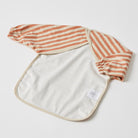 The smock turned over to show its open back and the plain cream inside of the front panel