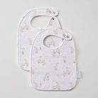 Two white muslin bibs overlapping, printed with small cream ducks and reeds, each with a rounded neck and a press stud at the strap