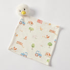 Cream jersey comforter laid flat, printed with blue and red tractors, a red barn, cows, hens and trees, a fluffy white duck's head with a yellow beak at the top corner