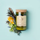 Oakmoss & Sage soy candle in a cork-topped reclaimed wine bottle with rosemary, lavender and orange