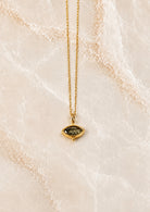 Fine gold chain necklace with a small olive-green marquise stone pendant in a beaded gold setting
