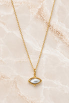 Fine gold chain necklace with a white pearl marquise pendant in a beaded gold setting