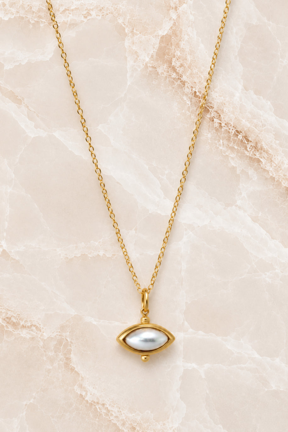 Fine gold chain necklace with a white pearl marquise pendant in a beaded gold setting