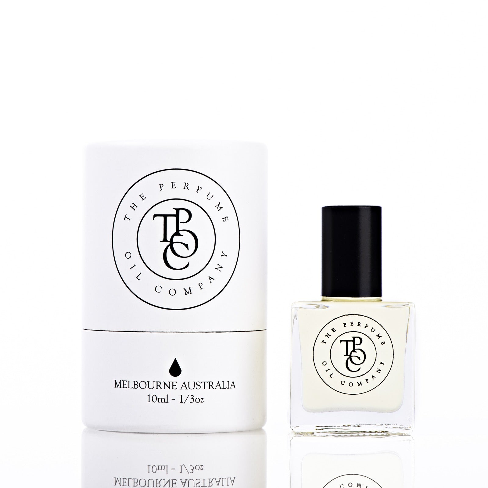 The Perfume Oil Company white gift cylinder beside a 10 ml bottle of perfume oil, front view