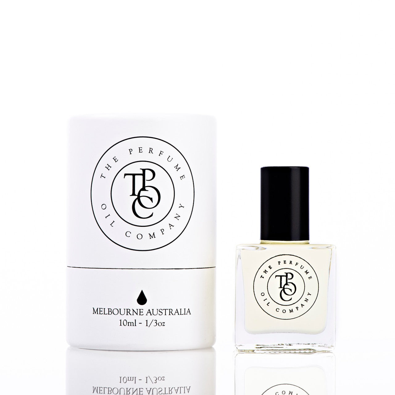 The Perfume Oil Company white gift cylinder beside a 10 ml bottle of perfume oil with a pale straw tint