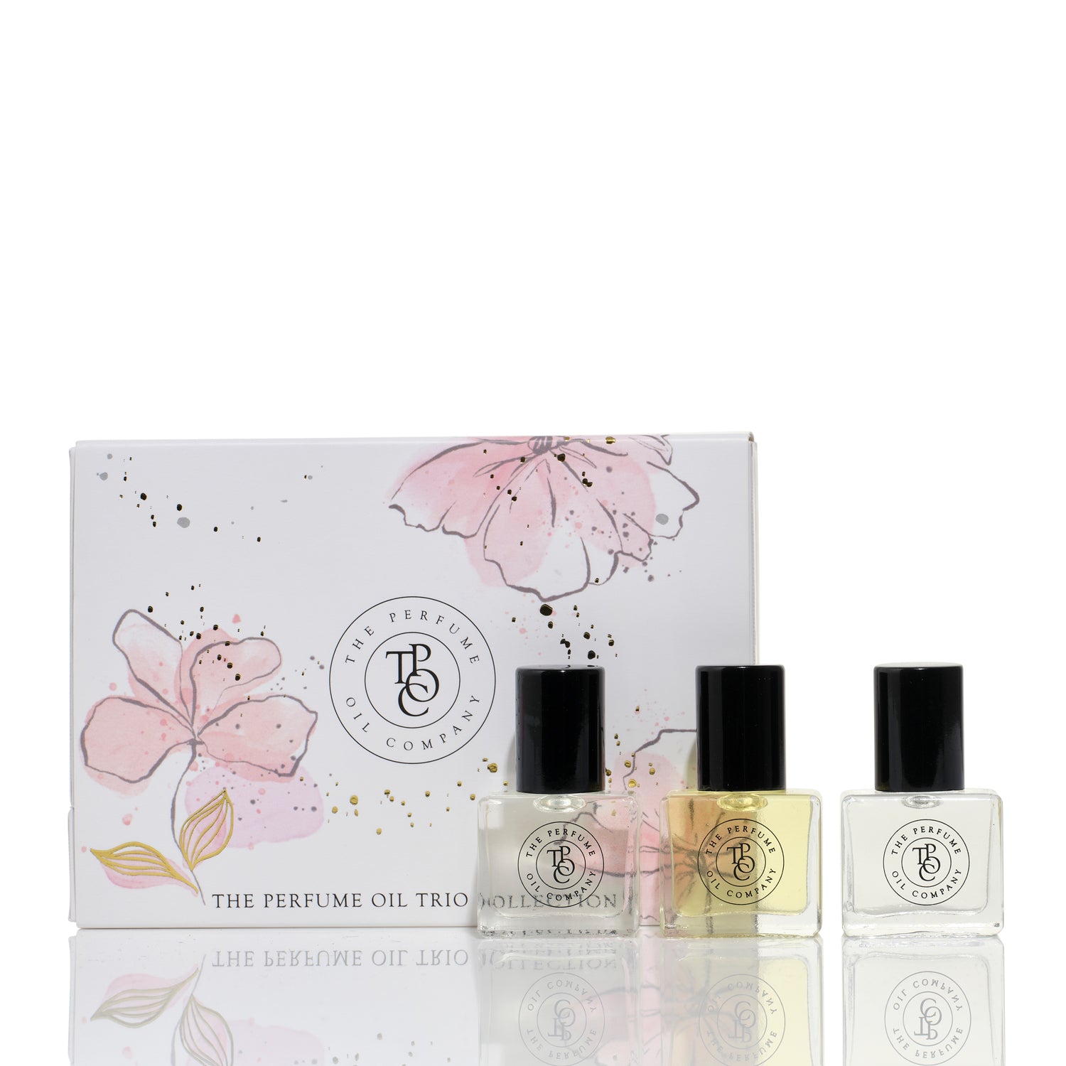 Sweet Triple Treat trio gift box with blossom artwork and three 5 ml roll-on perfume oils in front