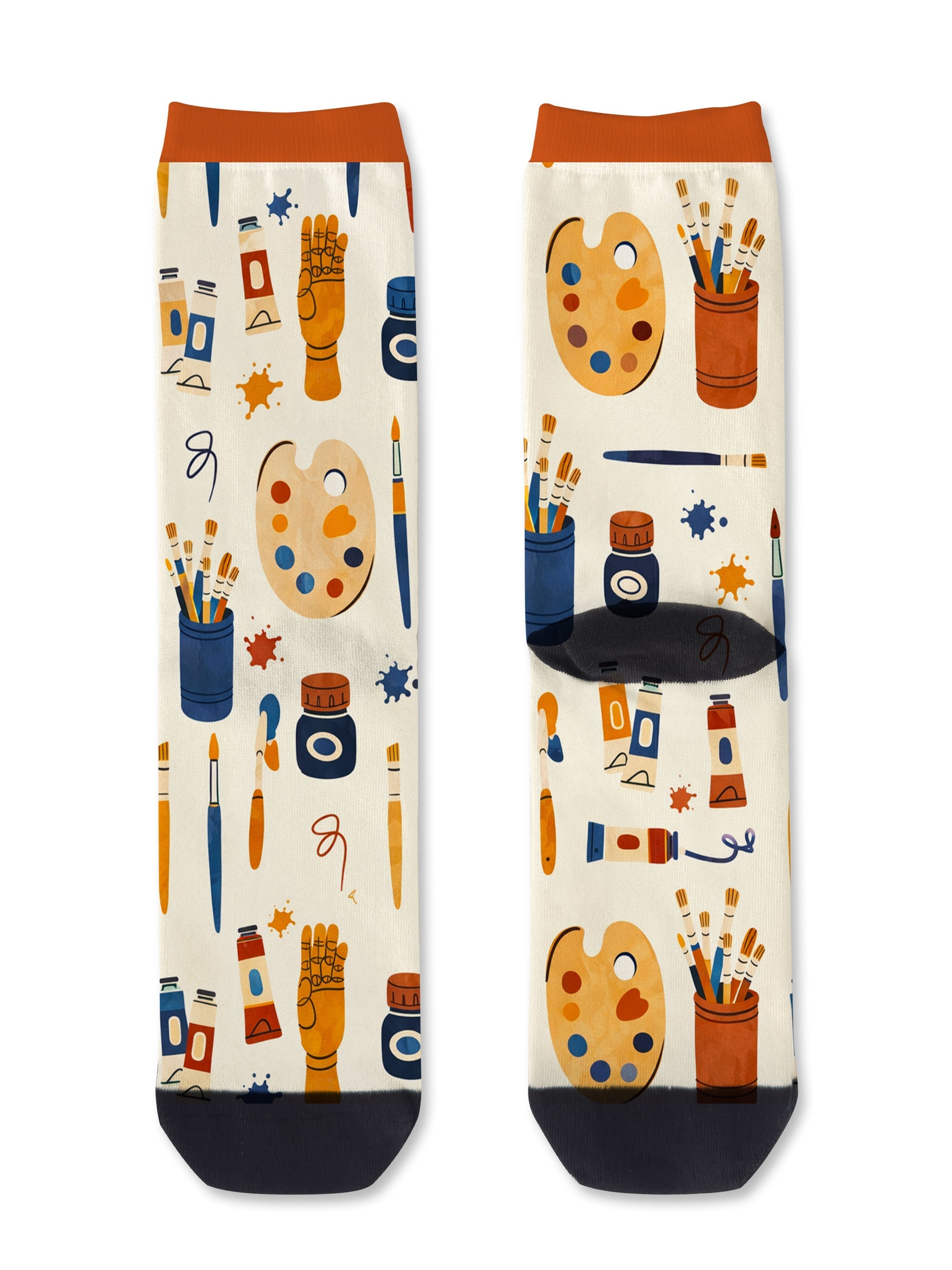 Pair of cream art supply socks stood upright side by side, showing the orange cuff and the full repeating palette and paintbrush pattern.