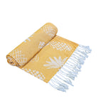 Pineapple Turkish towel rolled to show yellow and white pineapple jacquard with fringe