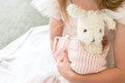 Child cuddling the Marshmallow puppy plush in its carrier