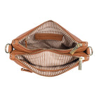 The tan bag unzipped from above, showing the striped fabric lining and inner pockets