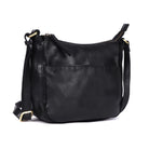 Black leather bag angled, showing the rounded base and front pocket