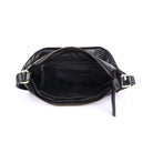 The black bag unzipped from above, showing the lining and inner pockets