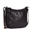 Brown leather bag angled, showing the rounded base and front pocket